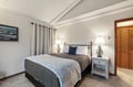 Sink into crisp linens and plump pillows in your elegantly appointed bedroom, where warm lighting and thoughtful touches create the perfect retreat.