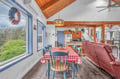 Gather around your charming dining table with rustic wood beams overhead and leafy views outside.