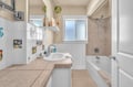 Your private bathroom offers both shower and soaking tub, with cheerful sea-themed tiles brightening your daily routines.