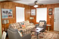 Settle into your cozy retreat with warm wood paneling, plush seating, and cheerful beach-inspired decor that instantly puts you in vacation mode.