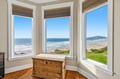 Picture yourself waking to this breathtaking ocean panorama. Gentle waves roll onto the sandy shore while coastal greenery frames your peaceful view. Natural light floods in, inviting you to breathe deeply and soak it all in.