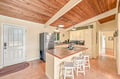 Gather around your spacious kitchen island under soaring wood-beamed ceilings. Modern appliances and cozy cottage charm make preparing meals as enjoyable as sharing them.