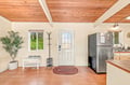 Step into your welcoming entryway with warm wood ceilings and an open layout that flows right into your fully equipped kitchen—a bright, airy space ready for you to settle in.