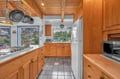 Cook your favorite meals in this well-equipped kitchen with warm wood cabinets, granite counters, and everything needed for memorable dining experiences.