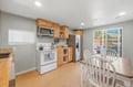 Prepare meals with ease in your fully-equipped kitchen, featuring modern appliances, ample counter space, and natural light streaming through the windows. The adjacent dining area leads to your private patio.