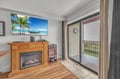 Unwind with tropical scenes on your large TV while the fireplace creates warmth and ambiance in your cozy living space.