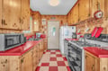 Your fully equipped kitchen welcomes you with warm knotty pine cabinets, bright red countertops, and everything needed to create memorable meals.