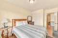 Settle into your cozy bedroom with its inviting wooden bed and warm lighting. You'll find ample storage in the closet and dresser, and enjoy the convenience of an ensuite bathroom just steps away.