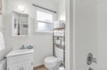 Fresh towels await in your spotless bathroom with natural light and thoughtful storage for all your essentials.
