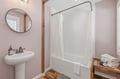 Step into your private bathroom, where warm wooden accents meet fresh, modern design. Fresh towels await, and the spacious tub invites you to relax after exploring.
