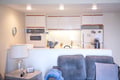 Unwind in your open-concept space where the cozy living area flows into a fully-equipped kitchen, perfect for easy meals and effortless relaxation.