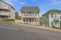 Charming coastal-style property nestled in a quiet neighborhood, offering easy access to local area attractions and scenic mountain backdrop.