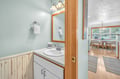 Your private powder room features calming blue walls and warm wood accents, creating a peaceful retreat.