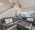 Settle into your spacious living area with soaring ceilings and a plush sectional that invites you to unwind. The open layout flows seamlessly into your fully-equipped kitchen, perfect for gathering and making memories.