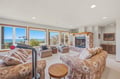 Settle into this bright, airy living space where panoramic ocean views greet you through floor-to-ceiling windows.