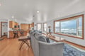 Unwind in your open-concept living space where panoramic ocean views frame your daily moments through expansive windows.