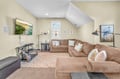 Sink into the plush sectional sofa and enjoy movie nights on your large TV in this cozy living space with vaulted ceilings.