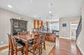 Step into your spacious open-concept kitchen and dining area, where warm wood tones and granite countertops create the perfect space for family meals.
