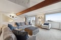 Unwind in your bright living space with exposed beam charm, plush seating, and coastal touches that create the perfect retreat.