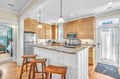 Your fully equipped kitchen features granite countertops, stainless steel appliances, and a breakfast bar where you can enjoy morning coffee.