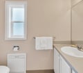 Your private bathroom features clean lines, soft neutral tones, and thoughtful touches like fresh towels artfully arranged just for you.