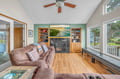 Sink into the plush sectional sofa and feel instantly at home in this bright living room with vaulted ceilings and a cozy fireplace.