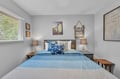 Sink into coastal comfort in your serene bedroom retreat, where soft blues and warm wood tones create a peaceful escape for restful nights by the sea.