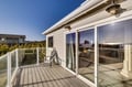 Step onto your private deck with sweeping views, where morning coffee and evening sunsets become daily rituals in this bright coastal retreat.