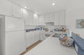 Your bright, fully-equipped kitchen features everything you need to prepare meals during your stay, from crisp white cabinetry to modern appliances and ample counter space.
