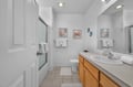 Step into your bright, spacious bathroom with coastal charm—soft towels await, and whimsical sea creature art adds a cheerful touch to your daily routine.