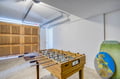 A fun game space awaits—challenge friends to foosball in this bright room with beach vibes just steps from the garage entrance.