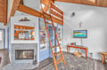 Unwind in your charming loft space with soaring wood beams, cozy fireplace, and thoughtful details that make you feel right at home.