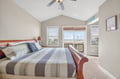 Wake up to breathtaking views from your comfortable bedroom, where coastal scenery stretches beyond your private balcony doors.