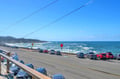 Stunning coastal road with ocean views and beachfront parking creates the perfect seaside escape backdrop.