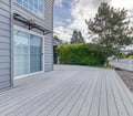 The spacious deck offers plenty of room to unwind, surrounded by mature trees and lush greenery that create a peaceful, private retreat for your outdoor moments.