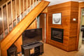 Your cozy retreat features warm wood paneling, a crackling fireplace to gather around, and a TV for movie nights after exploring the area.