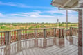 Spacious wooden deck with expansive natural landscape views stretching to the horizon.