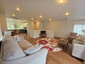 Relax in your spacious open-concept living area with plush seating, warm hardwood floors, and seamless flow to your fully-equipped kitchen.