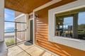 Step onto your private covered porch and feel the cool coastal breeze—your beachfront getaway is just beyond the door, with stunning water views framing every moment.