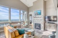 Relax in your bright living room with stunning views, cozy fireplace, and comfortable seating for memorable evenings.