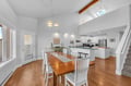 Gather around your spacious dining table in this bright, open-concept space with vaulted ceilings and warm wood floors for memorable meals together.
