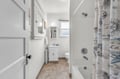 Step into your bright, clean bathroom with fresh towels and a relaxing tub-shower combo ready for your daily refresh.