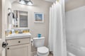 Refresh in your cheerfully decorated bathroom featuring coastal-themed touches, modern fixtures, and everything needed for a comfortable stay.