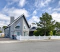 A charming coastal home nestled in a peaceful neighborhood, featuring classic architecture and lush surrounding greenery, perfect for your seaside getaway.