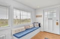 Settle into your cozy window seat with charming nautical pillows while gazing across peaceful countryside views.