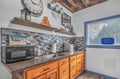Your well-equipped kitchenette features warm wood cabinets, modern appliances, and charming rustic touches for easy meal prep.