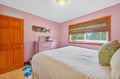 Rest peacefully in your charming pink bedroom with garden views and thoughtful touches that make this space feel like home.