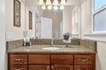 Your private bathroom features granite countertops, elegant vanity lighting, and thoughtful amenities for a comfortable stay.