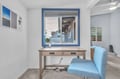 Settle into your bright workspace with ocean-inspired blues, where natural light streams through your window as you catch up on emails or plan adventures.