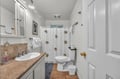 Step into your private bathroom featuring a spacious shower, vanity with stone countertop, and cheerful fish-themed curtain that adds coastal charm.